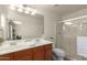 Bright bathroom features a double sink vanity with wood cabinets and a glass-enclosed shower at 2977 W Mira Dr, San Tan Valley, AZ 85144