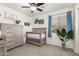 Stylish Bedroom featuring a gray crib, natural wood accents, and a bright window at 2977 W Mira Dr, San Tan Valley, AZ 85144