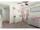 This cozy Bedroom features a white crib, soft pink accents, and neutral walls at 2977 W Mira Dr, San Tan Valley, AZ 85144