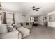 Inviting living room with ample seating, neutral decor, and lots of natural light from large windows at 2977 W Mira Dr, San Tan Valley, AZ 85144