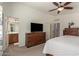 Large main bedroom with a TV, neutral walls and access to the ensuite bathroom at 2977 W Mira Dr, San Tan Valley, AZ 85144