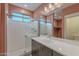 A modern bathroom featuring a glass-enclosed shower and vanity with a white countertop and neutral cabinetry at 300 N Gila Springs Blvd # 164, Chandler, AZ 85226