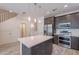 Contemporary kitchen with island, stainless steel appliances, and custom cabinets at 300 N Gila Springs Blvd # 164, Chandler, AZ 85226