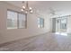 Spacious living room featuring wood-look flooring, modern chandelier, and natural light at 300 N Gila Springs Blvd # 164, Chandler, AZ 85226