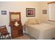 Simple bedroom design with antique washstand, neutral tones, and natural light at 3007 W Jordon Ln, Phoenix, AZ 85086