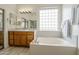 Bright bathroom with a soaking tub, double sinks, and a window offering natural light at 330 W Locust Dr, Chandler, AZ 85248