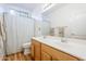 Bathroom featuring double sinks, wood cabinets, a large mirror, and a shower/tub combination at 330 W Locust Dr, Chandler, AZ 85248