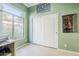 Bedroom with white closet doors, light wood floors, and a large window with natural light at 330 W Locust Dr, Chandler, AZ 85248