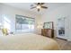 Comfortable bedroom with a large window view of the pool area and a dresser with mirror at 330 W Locust Dr, Chandler, AZ 85248