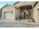 Charming front entrance with decorative door, desert landscaping, and a well-maintained three-car garage at 330 W Locust Dr, Chandler, AZ 85248