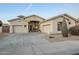 Inviting front exterior of a home with a three-car garage, desert landscaping, and well-lit entrance at 330 W Locust Dr, Chandler, AZ 85248