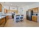 Bright kitchen featuring oak cabinets, stainless steel appliances, and bar seating at the kitchen island at 330 W Locust Dr, Chandler, AZ 85248