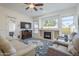 Comfortable living room with fireplace, large windows, and a view of the backyard and pool at 330 W Locust Dr, Chandler, AZ 85248