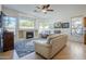 Inviting living room featuring a fireplace, large windows, hardwood floors, and comfortable seating at 330 W Locust Dr, Chandler, AZ 85248