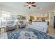 Bright living room with hardwood floors, a blue rug, and views into the kitchen area at 330 W Locust Dr, Chandler, AZ 85248