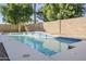 Backyard swimming pool featuring blue tile accents, a beautiful waterfall feature and lush, mature trees at 330 W Locust Dr, Chandler, AZ 85248