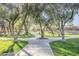 Scenic view of the neighborhood walking path featuring mature shade trees and manicured lawns at 330 W Locust Dr, Chandler, AZ 85248