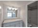 Updated bathroom with gray vanity, modern fixtures, and a combined shower and tub at 3500 N Hayden Rd # 2109, Scottsdale, AZ 85251