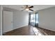 Bright bedroom featuring wood-look floors, a ceiling fan, and a large window with curtains at 3500 N Hayden Rd # 2109, Scottsdale, AZ 85251