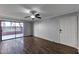 Bright living room features sliding glass doors to a patio, wood-look floors, and a white entry door at 3500 N Hayden Rd # 2109, Scottsdale, AZ 85251