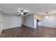 Spacious living room featuring wood-look floors, a ceiling fan, and a modern light fixture over the dining area at 3500 N Hayden Rd # 2109, Scottsdale, AZ 85251