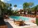 Community pool surrounded by lounge chairs and lush landscaping for relaxation at 3500 N Hayden Rd # 2109, Scottsdale, AZ 85251