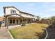 Expansive backyard featuring a well-manicured lawn, covered patio, and desert landscaping at 3551 E Shannon St, Gilbert, AZ 85295