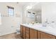 Bright bathroom featuring a double vanity with a large mirror, offering ample counter space and storage at 3551 E Shannon St, Gilbert, AZ 85295