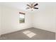 Bright bedroom featuring neutral carpet, a ceiling fan, and a window offering natural light at 3551 E Shannon St, Gilbert, AZ 85295