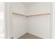 Walk-in closet, perfect for your wardrobe needs with a built-in wooden rod at 3551 E Shannon St, Gilbert, AZ 85295