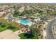 An aerial view features a sparkling community pool, ramada, and manicured landscaping in a residential neighborhood at 3551 E Shannon St, Gilbert, AZ 85295