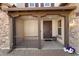 Welcoming front porch with sturdy columns, a dark wooden front door and decorative plants at 3551 E Shannon St, Gilbert, AZ 85295