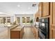 Bright kitchen featuring wooden cabinets, granite countertops, and modern appliances at 3551 E Shannon St, Gilbert, AZ 85295