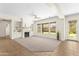 Inviting living room featuring a cozy fireplace, built-in shelving, and large windows at 3551 E Shannon St, Gilbert, AZ 85295