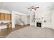 Spacious living room with a fireplace, built-in shelving, and a view of the staircase at 3551 E Shannon St, Gilbert, AZ 85295