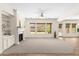 Bright living room with a fireplace, built-in shelving, and large windows overlooking the backyard at 3551 E Shannon St, Gilbert, AZ 85295