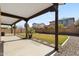 View under the covered patio with a view of the backyard and block fence at 3551 E Shannon St, Gilbert, AZ 85295