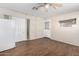 Living room features wood-look floors, neutral walls, two doorways, and a window with a white refrigerator at 3614 W Georgia Ave, Phoenix, AZ 85019