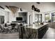 Elegant living room and kitchen area with modern lighting fixtures and neutral color palette at 37975 N 98Th Pl, Scottsdale, AZ 85262