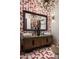 Modern powder room featuring red and white patterned tile floor, unique vanity, and decorative lighting fixture at 37975 N 98Th Pl, Scottsdale, AZ 85262