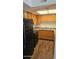 Kitchen features a black refrigerator and range, light countertops and wood cabinets at 3810 N Maryvale Pkwy # 1089, Phoenix, AZ 85031