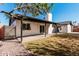 Backyard patio features a covered patio, grassy area, and concrete patio at 3927 W Phelps Rd, Phoenix, AZ 85053