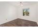 Bedroom featuring hardwood floors, ceiling fan, and a large window at 3927 W Phelps Rd, Phoenix, AZ 85053