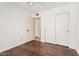 Bedroom with hardwood floors and a closet featuring sliding doors at 3927 W Phelps Rd, Phoenix, AZ 85053