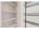 Organized closet with white shelving on the left and black wire baskets on the right at 3927 W Phelps Rd, Phoenix, AZ 85053