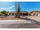 Home with desert landscaping featuring a yucca, dark garage door, and white exterior paint at 3927 W Phelps Rd, Phoenix, AZ 85053