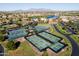 Community pickleball and tennis courts with lake and desert landscape in aerial view at 42024 W Rosewood Ln, Maricopa, AZ 85138