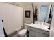 Neutral-toned bathroom featuring a shower-tub combo and an elegant vanity with countertop decor at 42024 W Rosewood Ln, Maricopa, AZ 85138