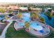 Aerial view of a community resort-style pool surrounded by palm trees and lounge chairs at 42024 W Rosewood Ln, Maricopa, AZ 85138