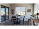 Bright dining area features a round table, stylish chairs, and sliding glass doors to outdoor living space at 42024 W Rosewood Ln, Maricopa, AZ 85138